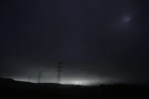 Japan Prints: Light and power lines come from tsunami-crippled Daiichi nuclear power plant as seen