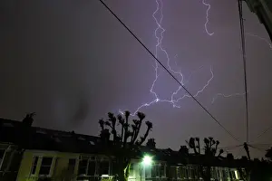 Weather Prints: Lightning is seen from a bedroom window as it strikes above a street in south London