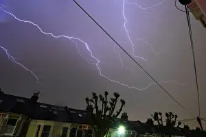 Weather Prints: Lightning is seen from a bedroom window as it strikes above a street in south London