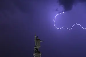 Spain Prints: Lightning is seen in the sky above the Christopher Columbus monument at Madrids Colon