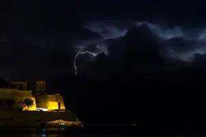 Malta Prints: A lightning storm is seen beyond the entrance to Vallettas Grand Harbour