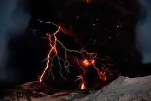 Lightning streaks across the sky as lava flows from a volcano in Eyjafjallajokul Lightning streaks across the sky as lava flows from a volcano in Eyjafjallajokul