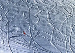 A lone snowboarder slides down a hill near the ski resort of Arosa
