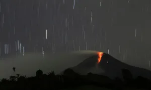 Indonesia Prints: A long exposure photo shows star trails as Mount Sinabung volcano spews hot lava as seen