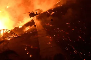 Wildfire Prints: A Los Angeles County fire helicopter makes a night drop while battling the so-called Fish