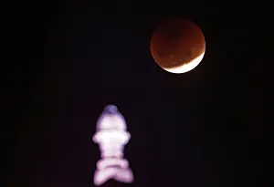 Lunar Prints: A lunar eclipse of a full Blue Moon is seen over the building of Indias Ministry of