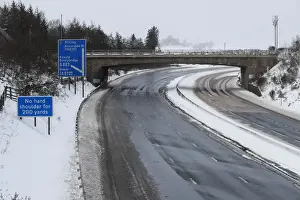 Britain Prints: The M80 motorway is completely empty after being closed to clear vehicles stranded by bad