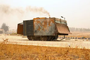 A makeshift military front loader drives in Dahiyat al-Assad, west Aleppo city