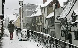United Kingdom Prints: Man braves wintry conditions in Old Hastings in Sussex southern England