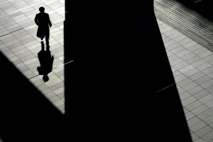 Man casts his shadow on the ground at Akihabara Electric Town, the largest electronics