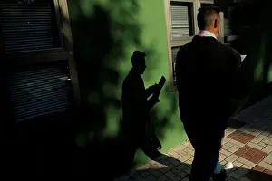 Spain Prints: A man checks his documents after leaving a government-run job centre in Malaga