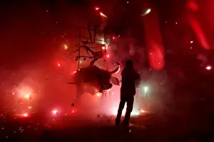Mexico Prints: Man enjoys the fireworks exploding from a traditional bull figure known as El Torito in