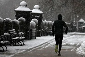 Weather Prints: A man jogs during a snowstorm in upper Manhattan in New York City