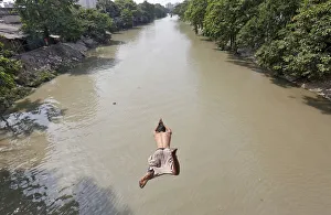 A man jumps into Tollys Nullah to cool off on a hot day in Kolkata A man jumps into Tollys Nullah to cool off on a hot day in Kolkata