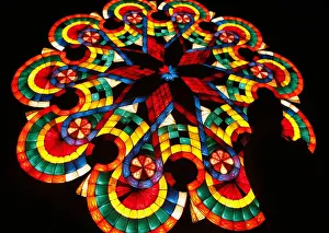 A man lights a cigarette in front of a giant lantern during the Christmas Lantern