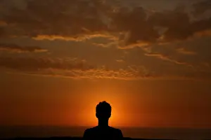 A man observes sunset in front of Limas Miraflores district in Peru