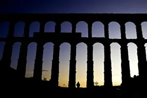 Man passes in front of Segovias 2, 000-year-old Roman aqueduct in central Spain