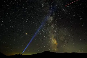 Meteor Prints: A man points his light at the Milky Way during the peak of the Perseid meteor shower in