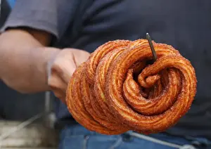 Religion Prints: A man prepares traditional sweets for sell during the holy fasting month of Ramadan at a