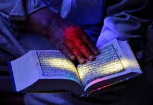 A man reads the Koran at the shrine of Sheikh Abdul Qadir Jeelani, a Sufi saint, during A man reads the Koran at the shrine of Sheikh Abdul Qadir Jeelani, a Sufi saint, during