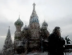 Prints of A man is seen through an iced window walking past St. Basils Cathedral in Moscows Red Square January 24, 2006 Russia Prints: A man is seen through an iced window walking past St