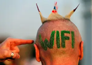 A man shows himself his hair style during ceremony known as Wai Kru to pay respects to