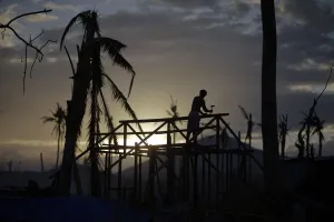 Philippines Prints: A man is silhouetted as he builds a wooden house in an area destroyed by Typhoon Haiyan