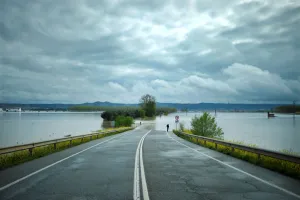 Spain Prints: A man stands on a road flooded by waters from the River Ebro