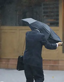 Typhoon Prints: A man struggles against a strong wind and rain caused by approaching Typhoon Wipha at a