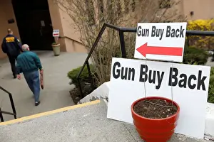 Prints of A man walks with his firearm during a community gun buy-back program in White Plains, New York, U.S. April 13, 2018. REUTERS/Shannon Stapleton USA Prints: A man walks with his firearm during a community gun buy-back program in White Plains