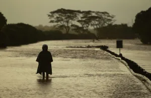 Indonesia Prints: A man walks through the flooded Jakarta-Merak toll road to reach near Serang