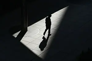A man walks on a footbridge in Tokyos Shiodome business district in Tokyo