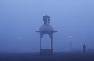India Prints: A man walks on a road amidst heavy fog on a winter morning in New Delhi