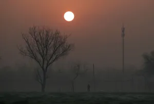 Prints of A man walks during sunrise in smog on a polluted day as a red alert issued for air pollution in Beijing, China, December 19, 2016. REUTERS/Jason Lee TPX IMAGES OF THE DAY China Prints: A man walks during sunrise in smog as a red alert issued for air pollution in Beijing