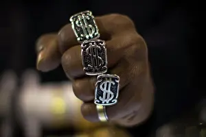 Editor's Picks: A man wears dollar sign rings in a jewellery shop in Manhattan in New York City