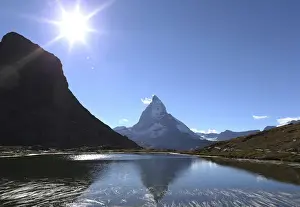 The Matterhorn mountain is reflected in the lake Riffel near Zermatt