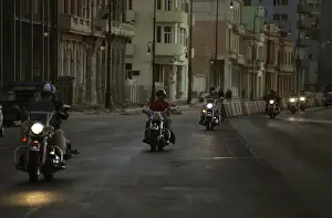 Members of the Friends of Fangio motoring club ride their Harley-Davidson motorcycles