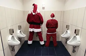 Two men dressed as Santa Claus use a toilet in Citta Sant Angelo near Pescara