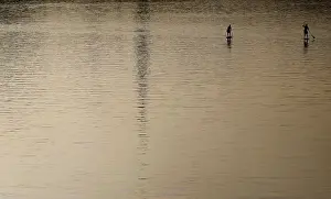 Abstract Prints: Two men enjoy a sunny afternoon as they paddle on the river Main in Frankfurt