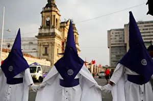 Men take part in a Procession of Jesus Nazareno de Candelaria Cristo Rey in the streets