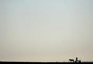 Men ride a horse-drawn wagon near the village of Tsalapitsa