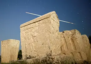 Meteor Prints: A meteor streaks past stars in the night sky above medieval tombstones during the Perseid