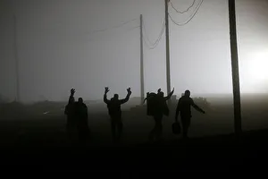 Migrants follow railway tracks towards the Canada-U. S. border as seen from Emerson