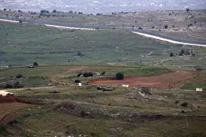 Mideast Prints: Military vehicles can be seen positioned on the Israeli side of the border with Syria