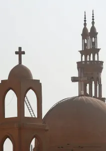 Religion Prints: Minarets of a mosque and the cross above a church is seen during the Muslim holy fasting