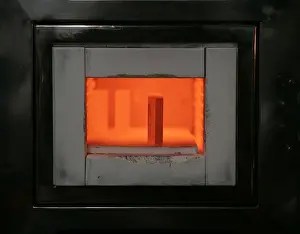 A mold for forming gold bars is kept at high-temperature in an oven at a Tanaka Kikinzoku