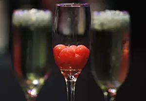 Molecular cocktails with balls made of fruits are displayed on a table at a bartender