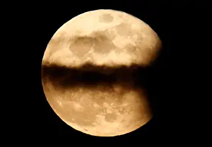 Macedonia Prints: The full moon named the Pink Moon rises over statues at city square in Skopje