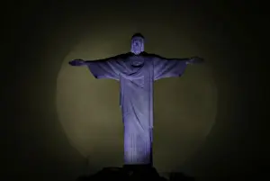 The moon is pictured behind the Christ the Redeemer statue ahead of the visit of Pope