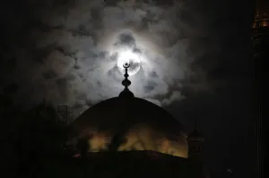 Images Dated 2012 May: A full moon is seen behind the minaret of Mohamed Ali mosque, in Islamic Cairo